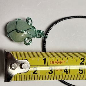 Handmade wire wrap stone pendant with cord.